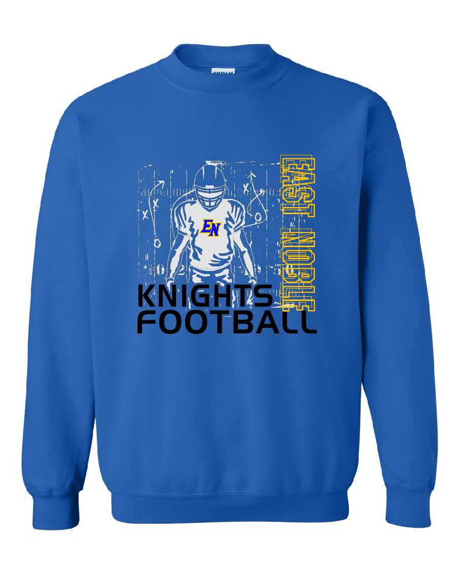 A royal blue crewneck sweatshirt featuring a graphic design for 'East Noble Knights Football'. The design includes a blue line-art illustration of a football player with a 'KN' logo on the chest, the words 'KNIGHTS FOOTBALL' in black, and 'EAST NOBLE' in yellow outlined text running vertically on the right.