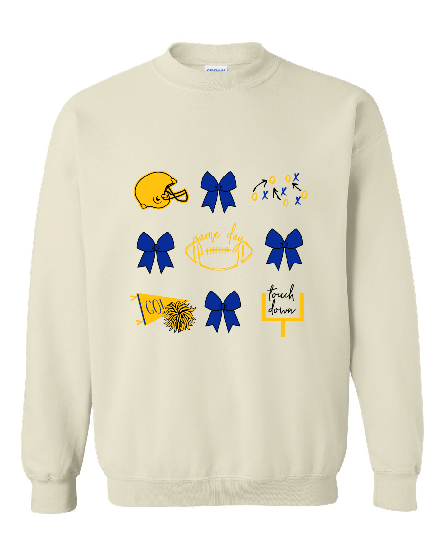 An off-white baige crewneck sweatshirt featuring a graphic print of football, cheerleaders, and the words 'game day' and 'touch down' in blue and yellow.