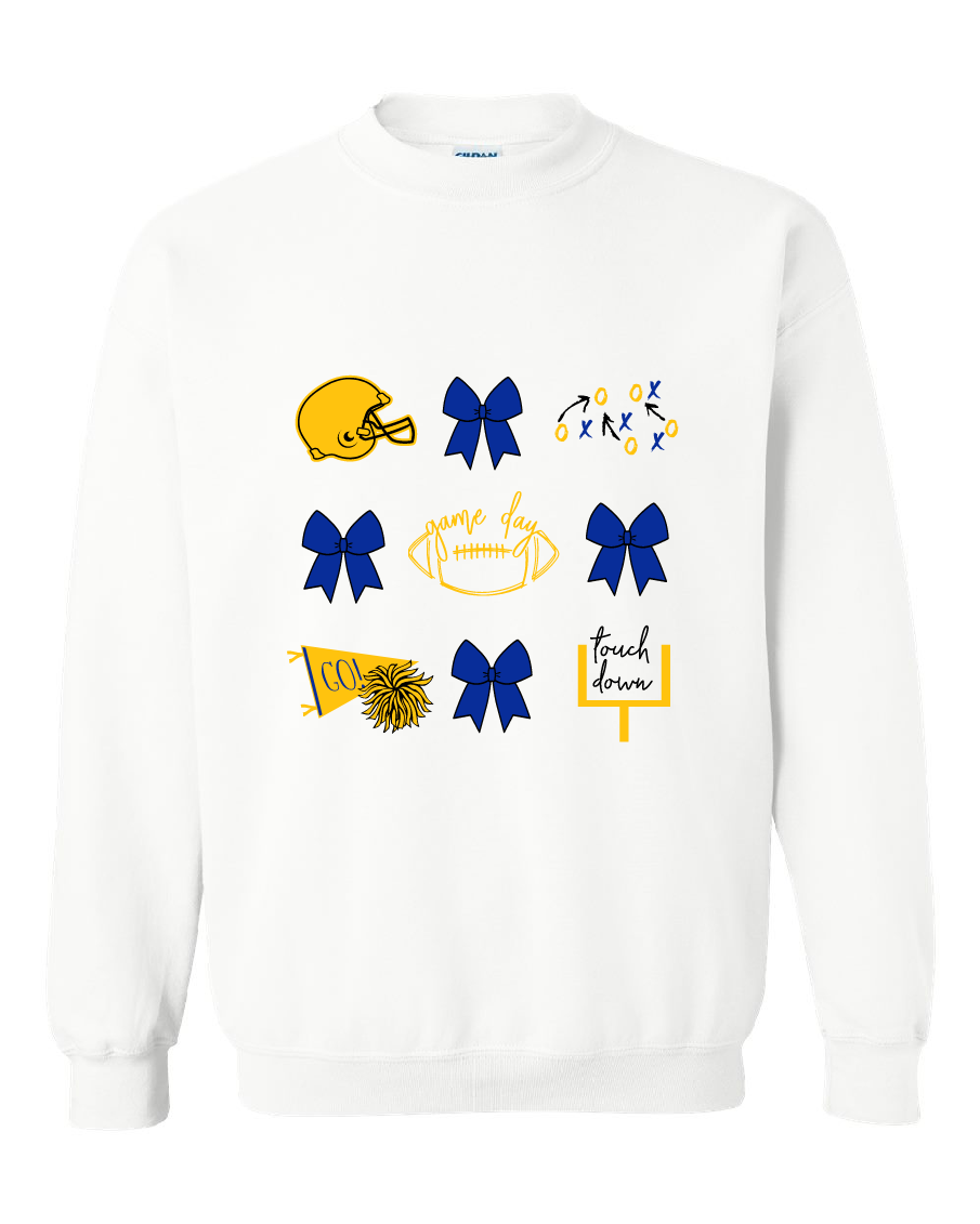 A white crewneck sweatshirt featuring a graphic print of football and cheer elements, including a yellow helmet, blue and yellow bows, a football with 'game day' written on it, a cheerleader pom-pom, and a 'touch down' sign.