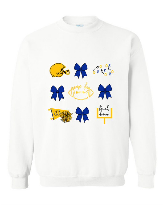 A white crewneck sweatshirt featuring a graphic print of football and cheer elements, including a yellow helmet, blue and yellow bows, a football with 'game day' written on it, a cheerleader pom-pom, and a 'touch down' sign.