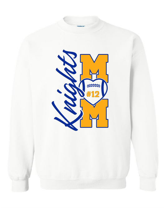 A white crewneck sweatshirt featuring a blue and yellow graphic on the front. The design displays the word 'Knights' in blue script alongside two large yellow block letters 'M' and 'M' stacked vertically, with a blue and yellow football heart in the center containing the text '#12'.